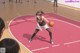 A woman dribbling a basketball on a basketball court.