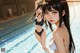 A couple of women standing next to each other near a swimming pool.