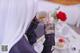 A woman sitting at a table with a cup of tea.