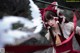 A woman in a red and white outfit holding a sword.